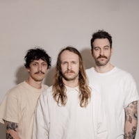 three men with tattoos posing for a photo